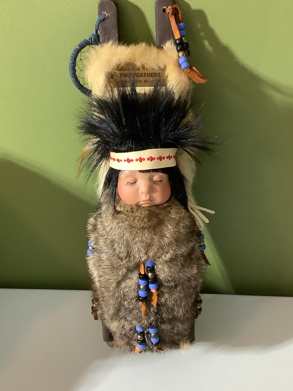 Two Feathers porcelain papoose doll
